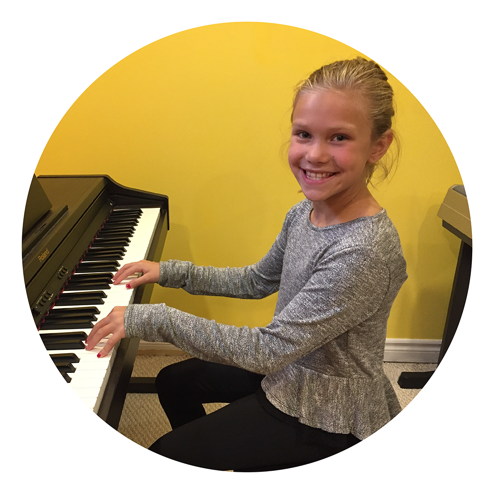 smiling child playing piano